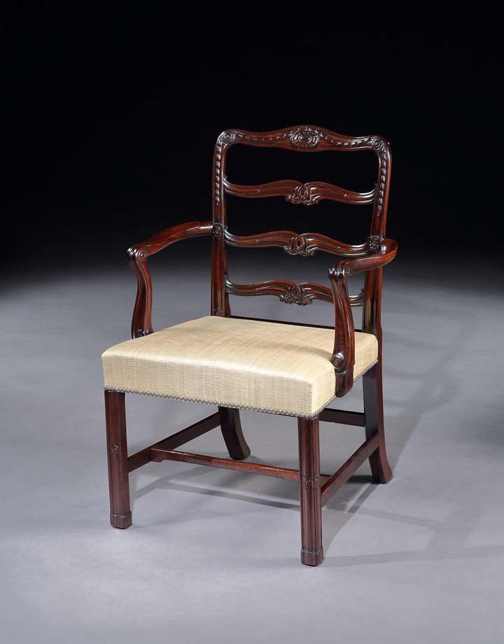 A pair of mahogany ladder back armchairs